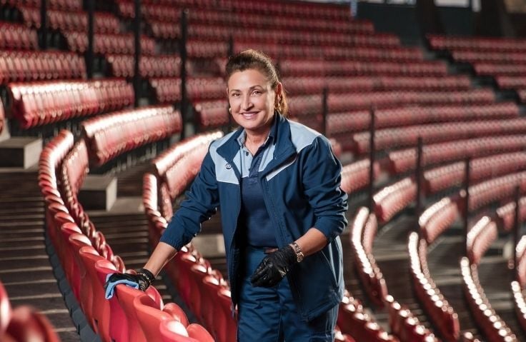 ISS female Placemaker in stadium cleaning seats
